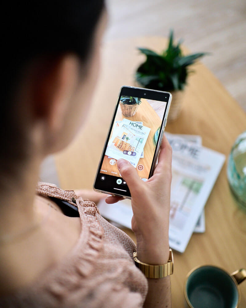 Photo de Joyce avec smartphone, pour le service communication de la Com'Fraîche